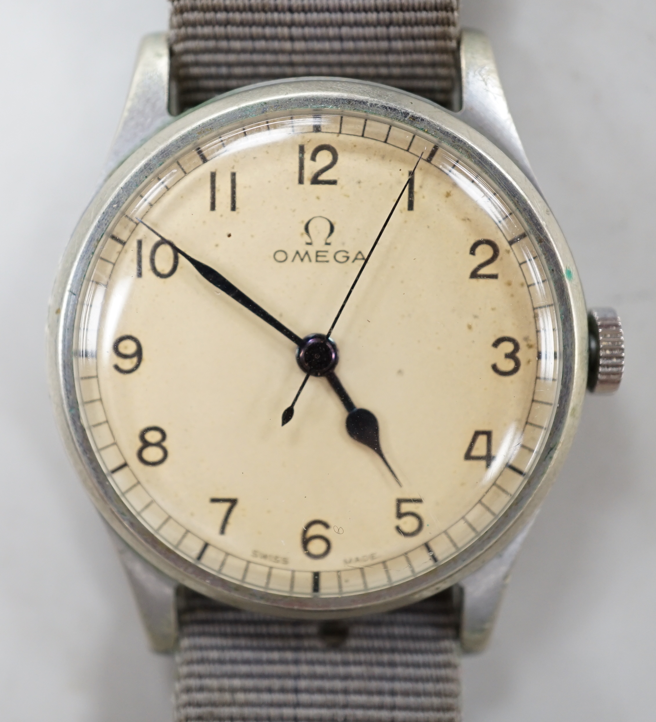 A gentleman's early 1940's stainless steel military issue Omega manual wind wrist watch, on fabric strap, the case back inscribed 'HS arrow 8 over 3282', movement c.30T2.